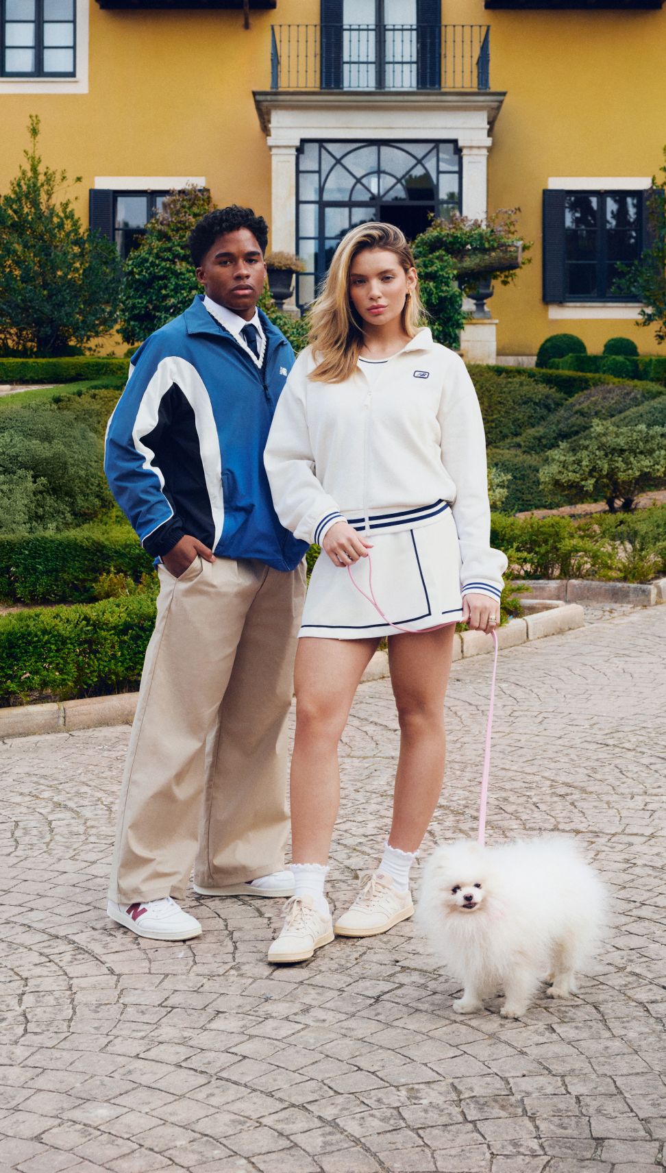 Endrick and Gabriely outside a large mansion wearing New Balance T500 sneakers.