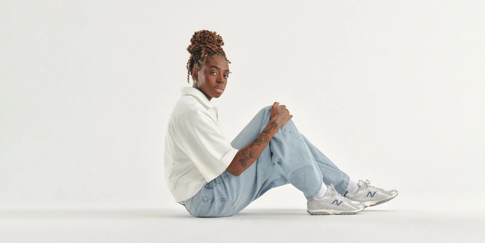 Can Burns sitting on a white studio backdrop. 