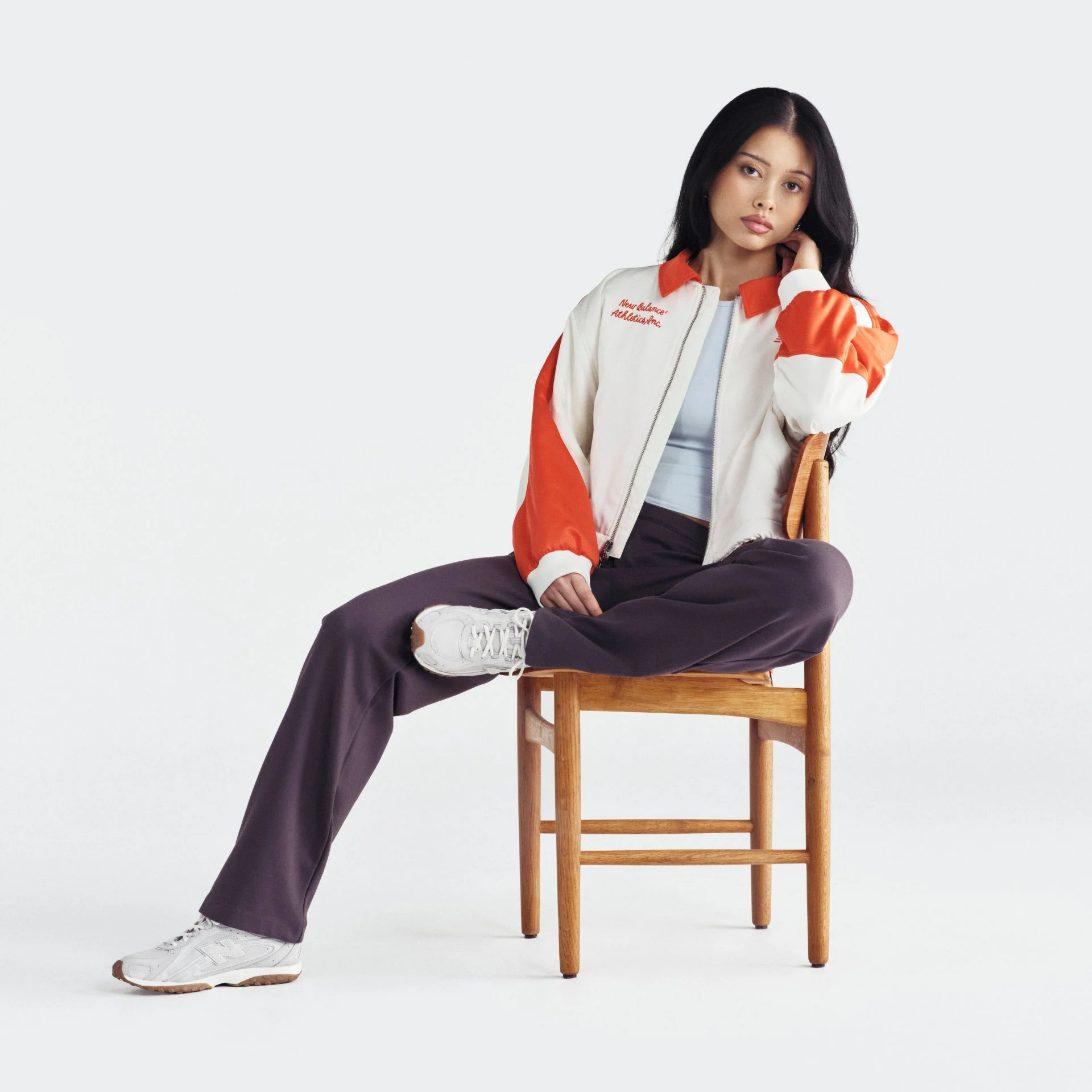 Woman in a studio background wearing 204L sneakers