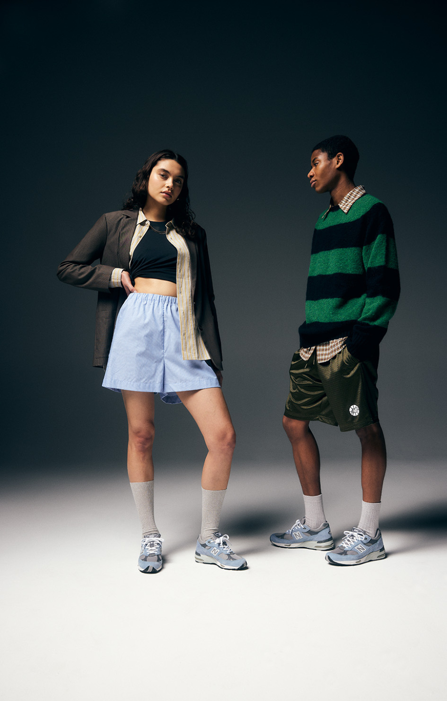 a man and woman wearing New Balance 991 runners