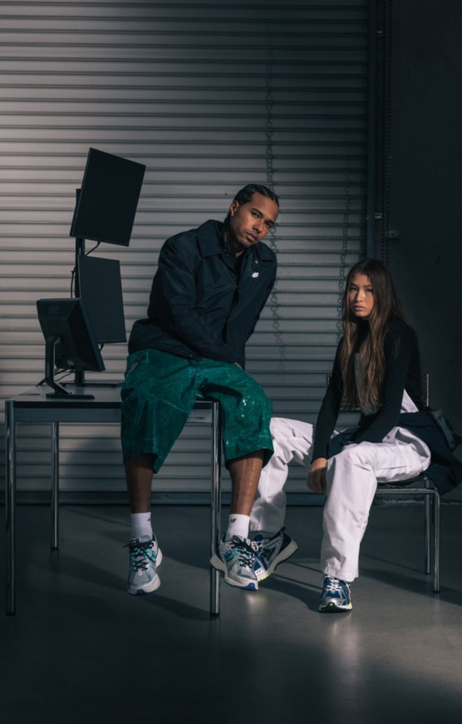 man standing and woman sitting in new balance 1906's