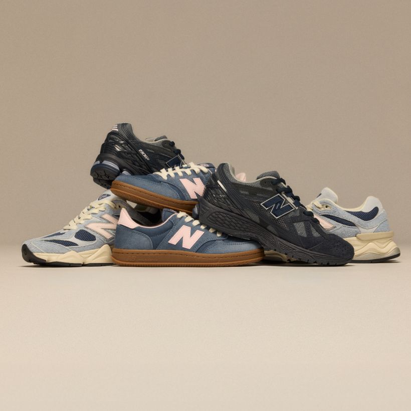 Pile of New Balance sneakers on beige background