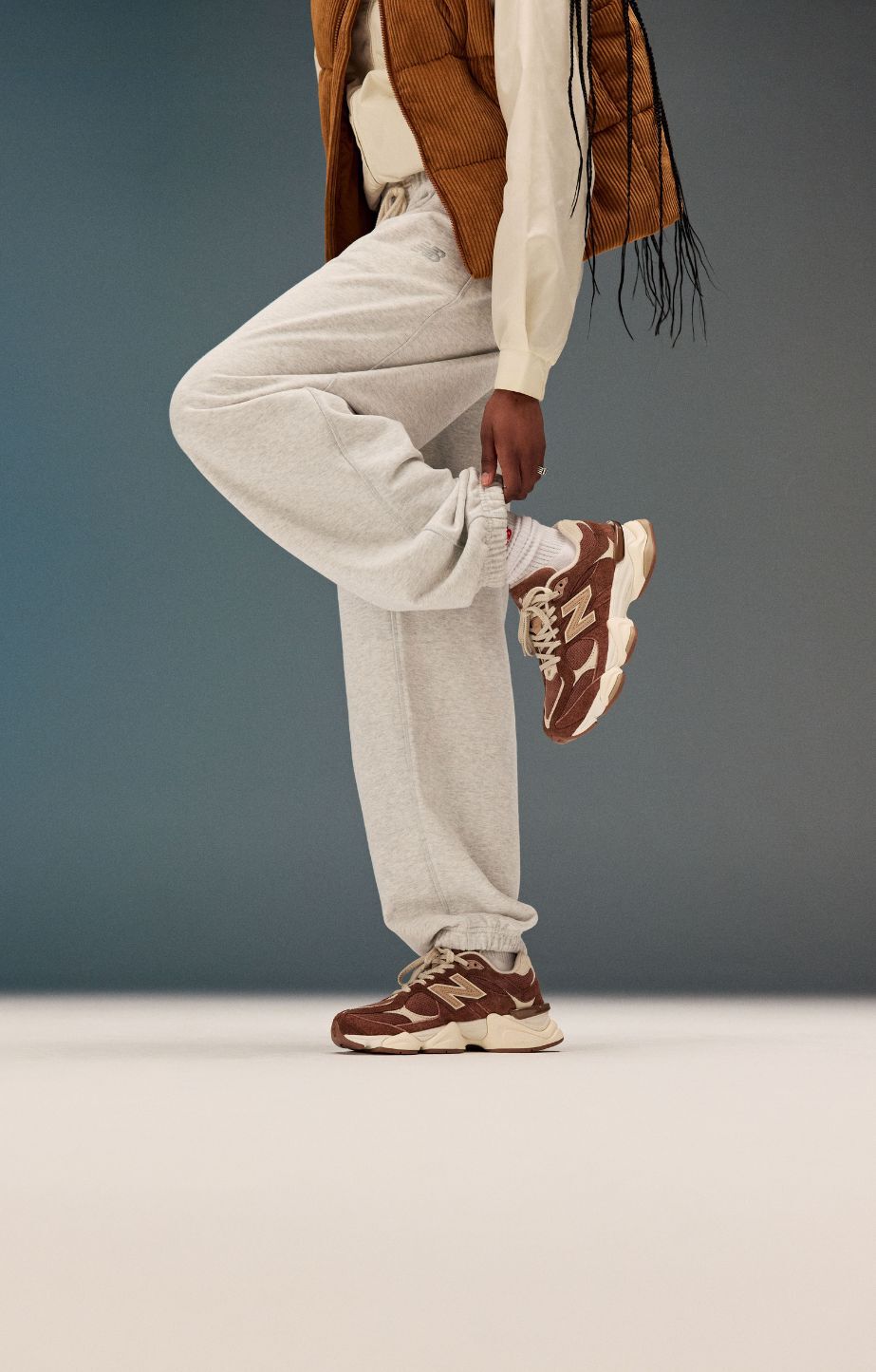 A woman wearing new balance 9060s