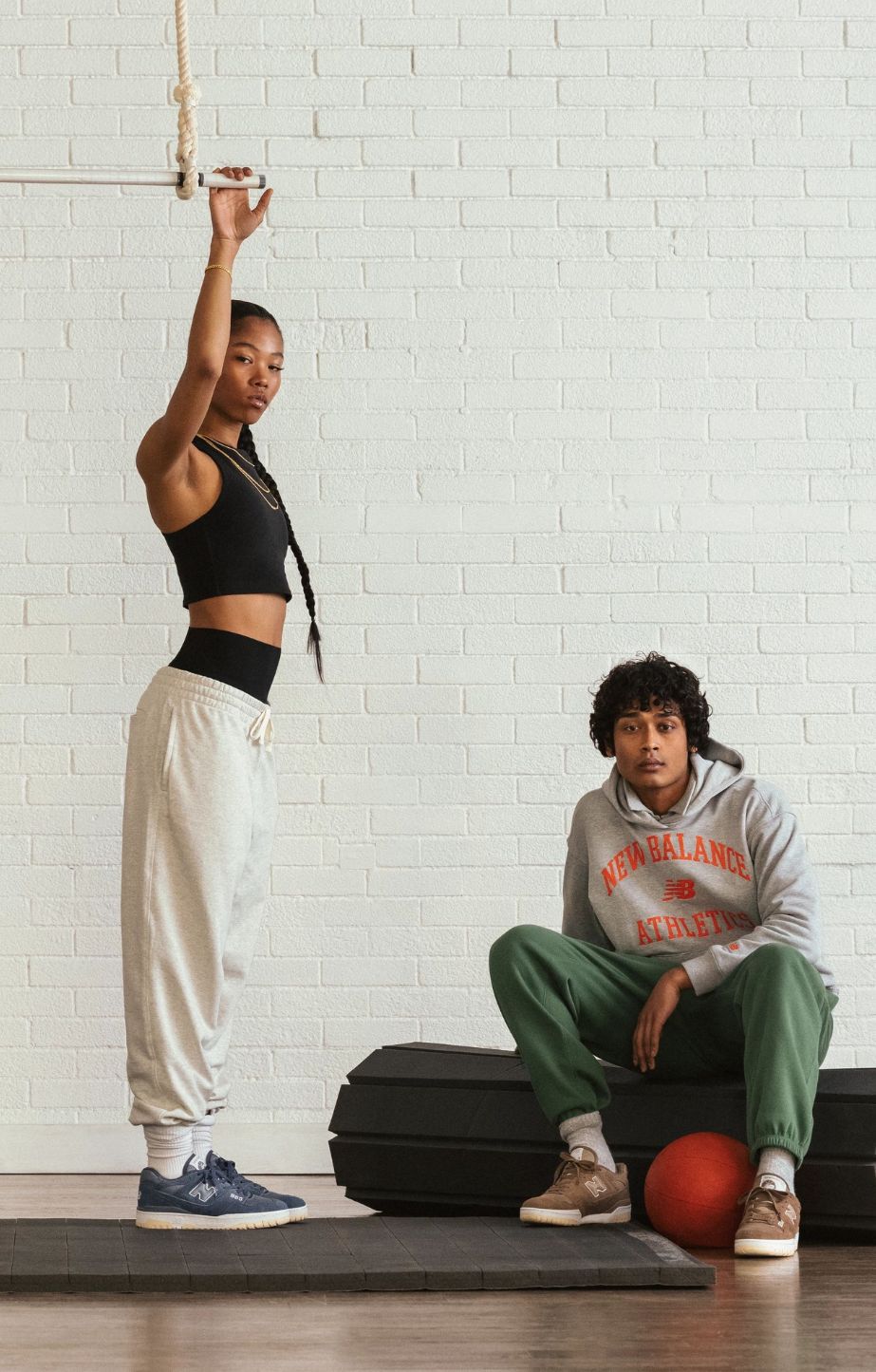 A man and woman wearing New Balance 550's 
