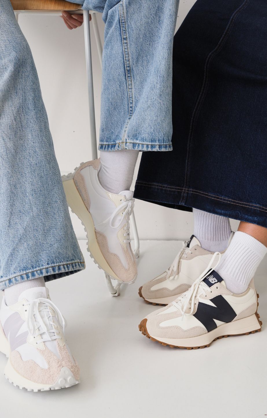 Close-up of two women wearing New Balance 327 sneakers