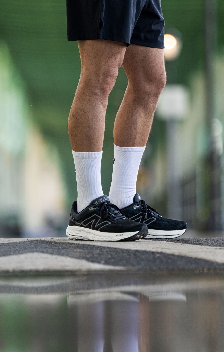 A man standing and wearing new balance fresh foam 860 running shoes