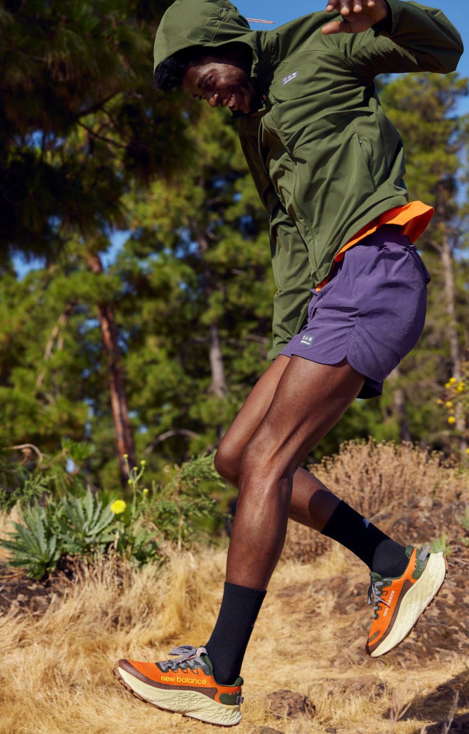 man running outdoors in New Balance trail shoes and clothing