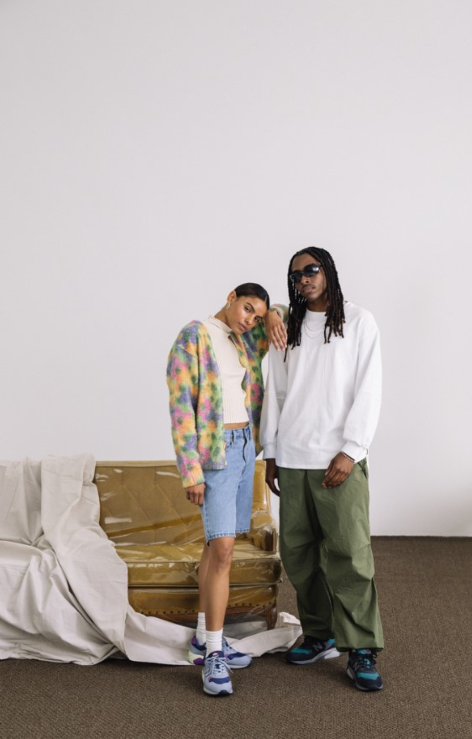 a man and woman wearing New Balance 580 Runners