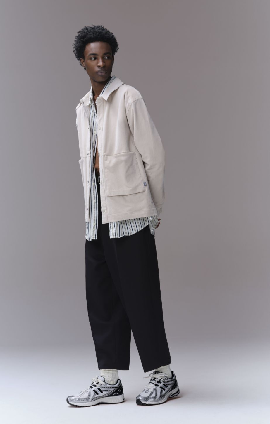 Person standing and wearing new balance 1906 sneakers
