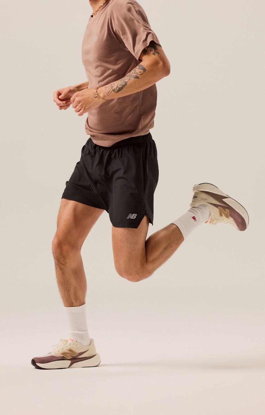 A man running and wearing new balance fuelcell running shoes