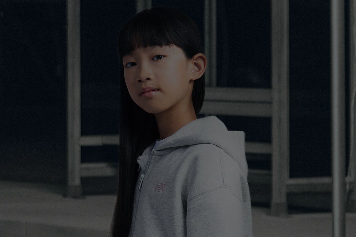 Girl wearing grey New Balance hoodie