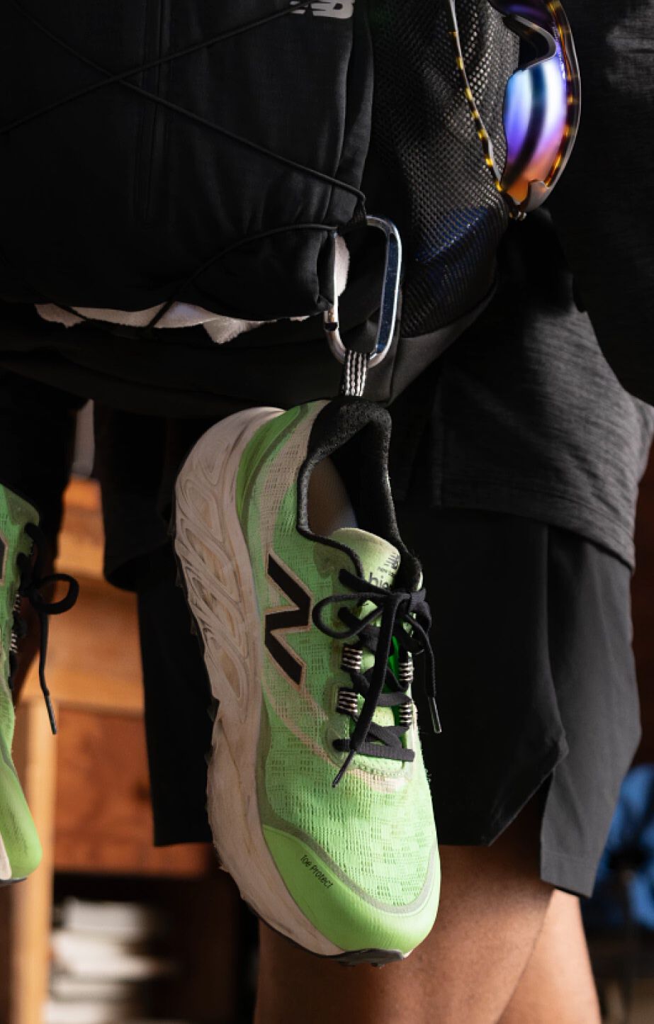 A pair of New Balance Fresh Foam X Hierro v9 hanging from a backpacking backpack. 