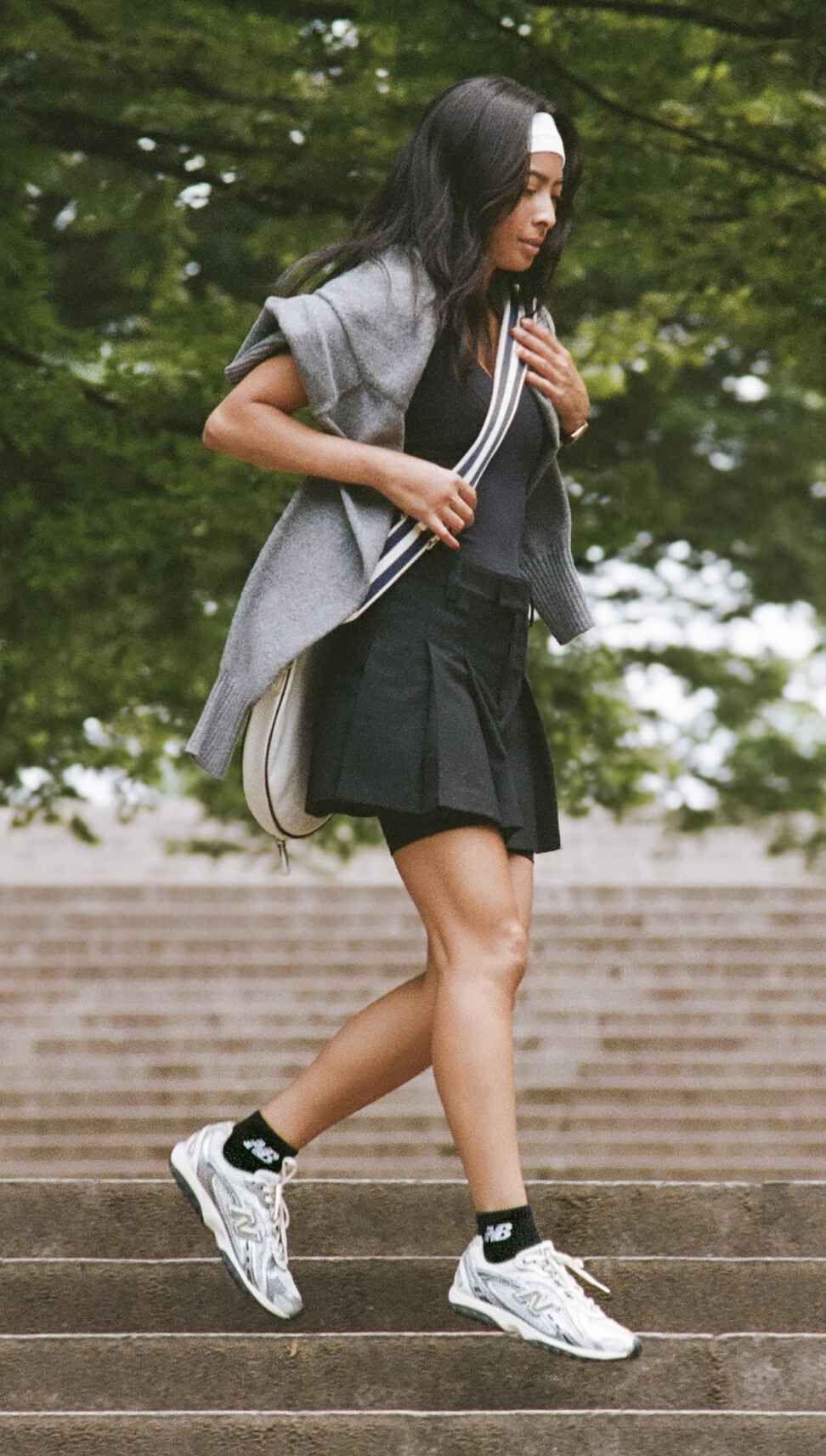 A woman walking down steps in a park setting