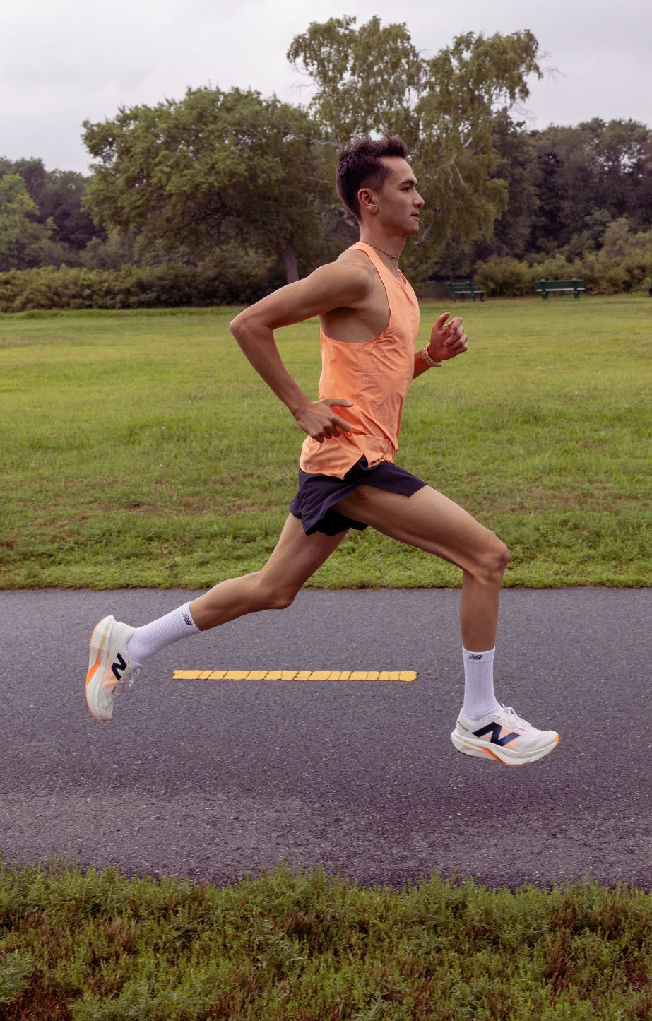 Man running wearing new balance fuelcell SC elite running shoes