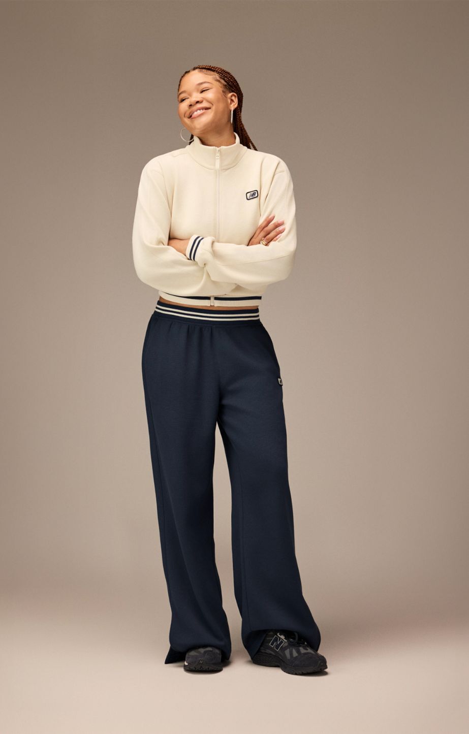 An individual stands wearing the 1906 sneakers