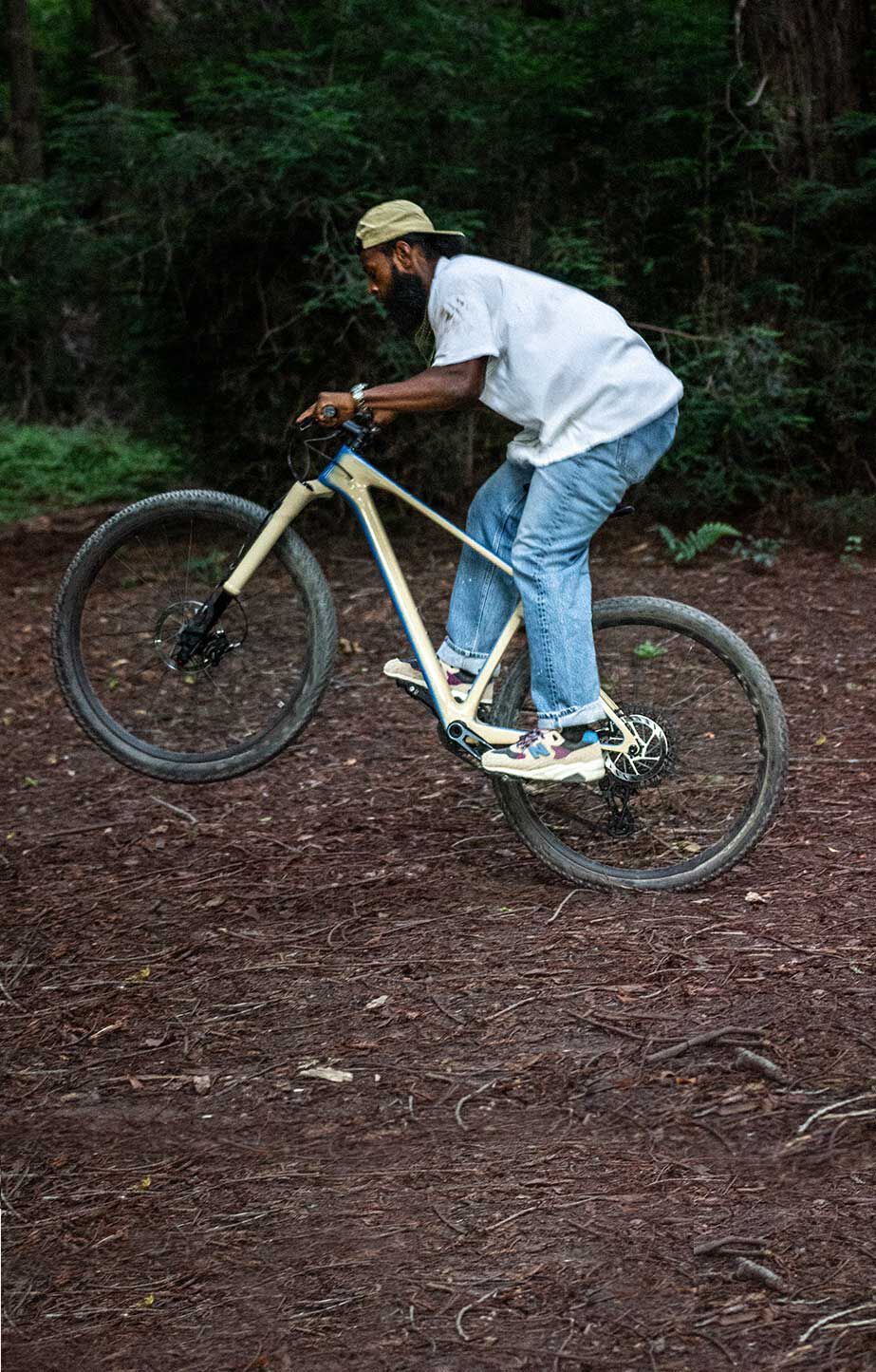 A man on a bike wearing Levis x New Balance 580 shoes