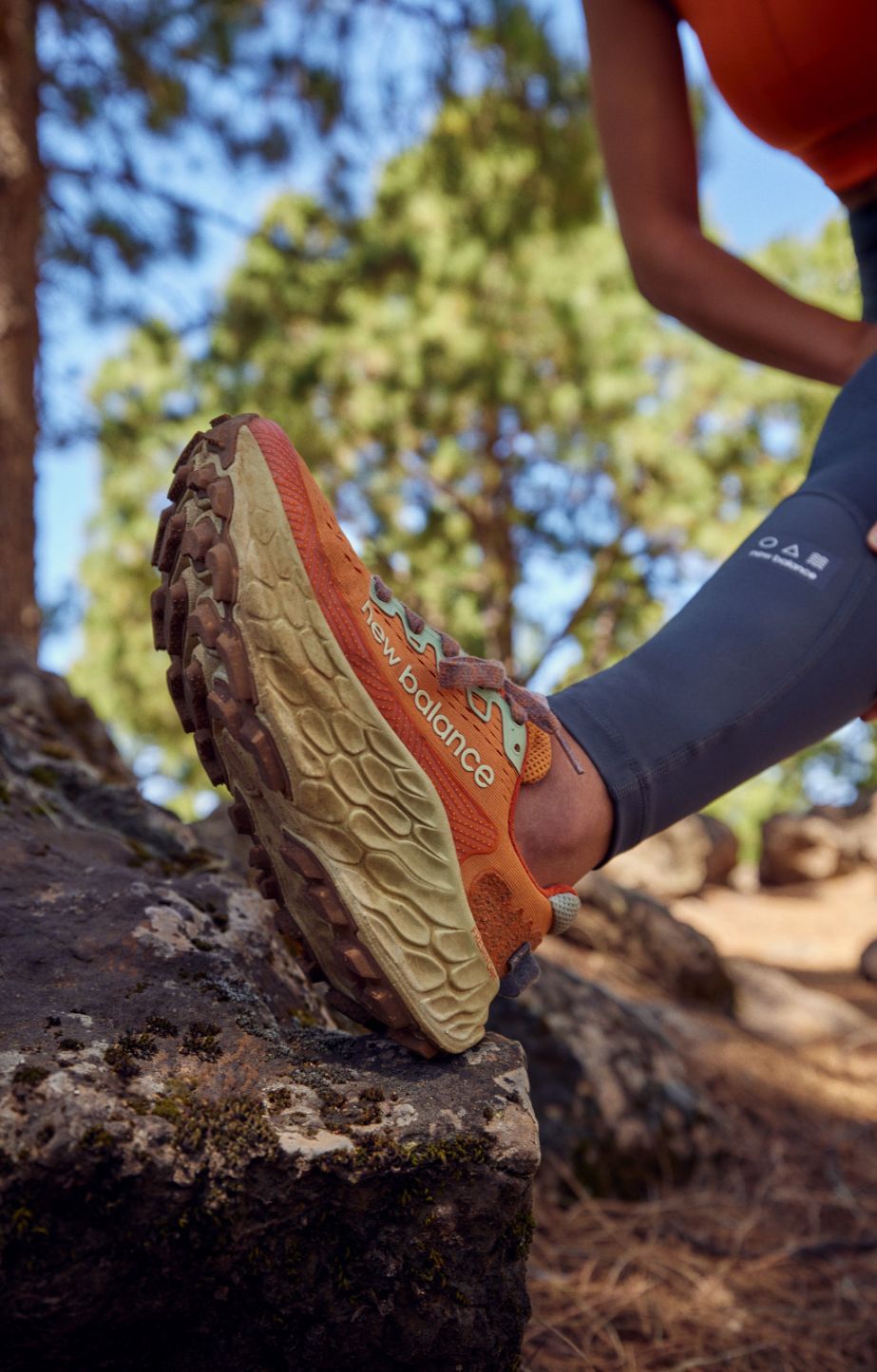 Woman stretching in New Balance More Trail runners