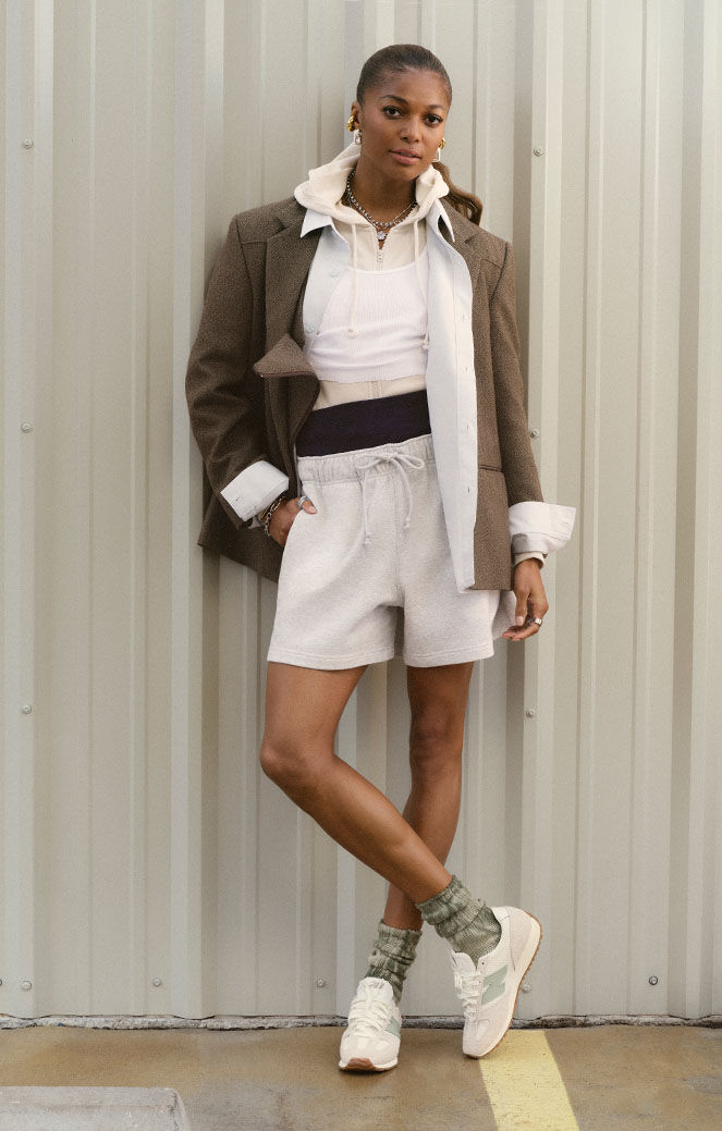 Gabby Thomas standing against a metal wall.