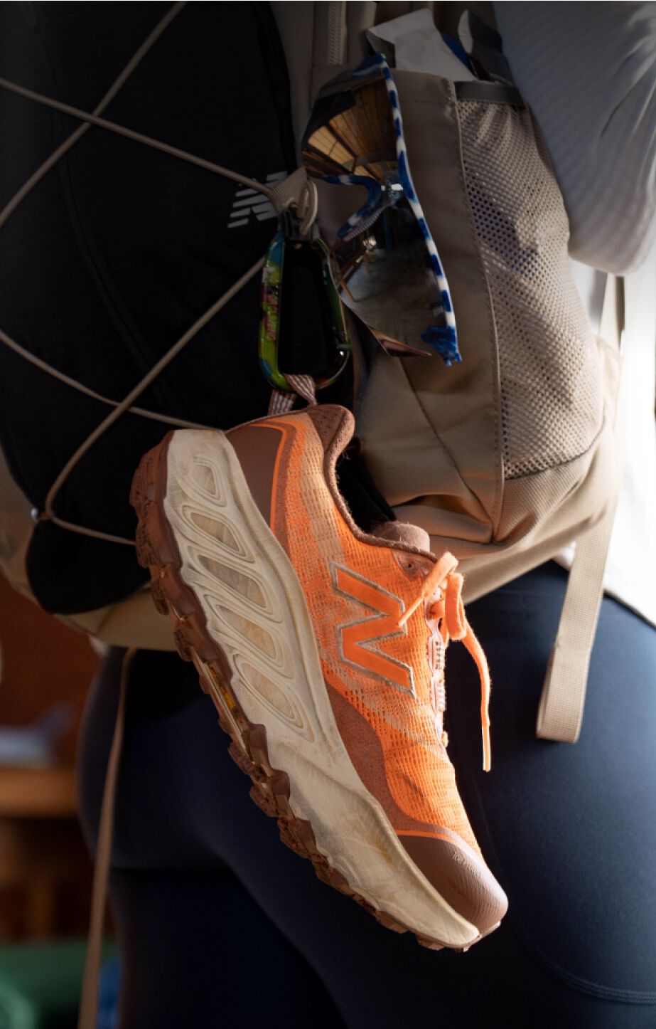 A pair of New Balance Fresh Foam X Hierro v9 hanging from a backpacking backpack.