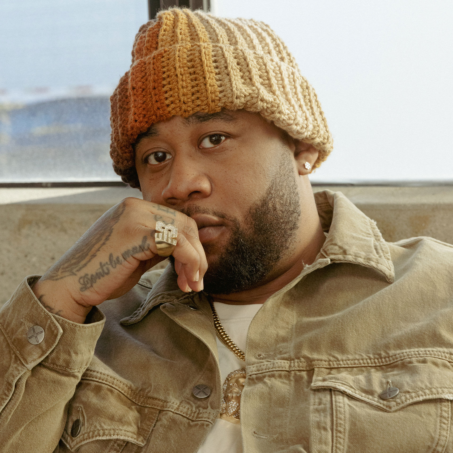 Close up shot of a Joe Freshgoods sitting down wearing New Balance clothing