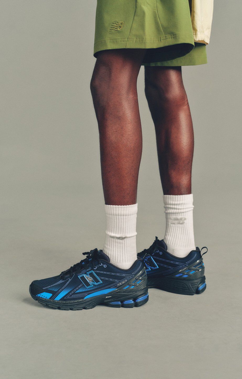 An individual stands wearing the 1906 sneakers
