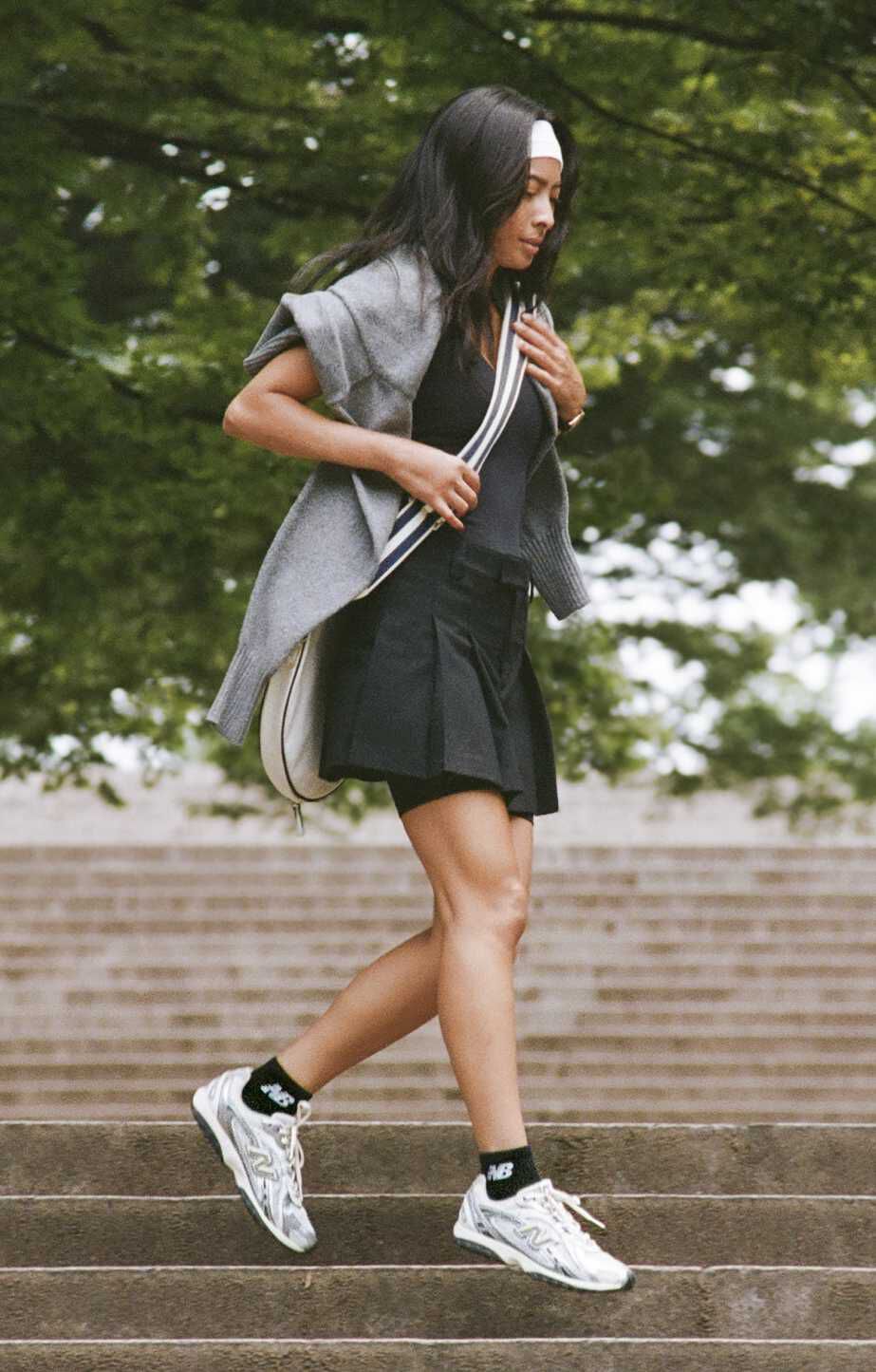 A woman walking down steps in a park setting.