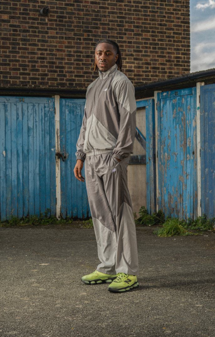 Eberechi Eze wearing the lime green shoes with his hands in his pockets 