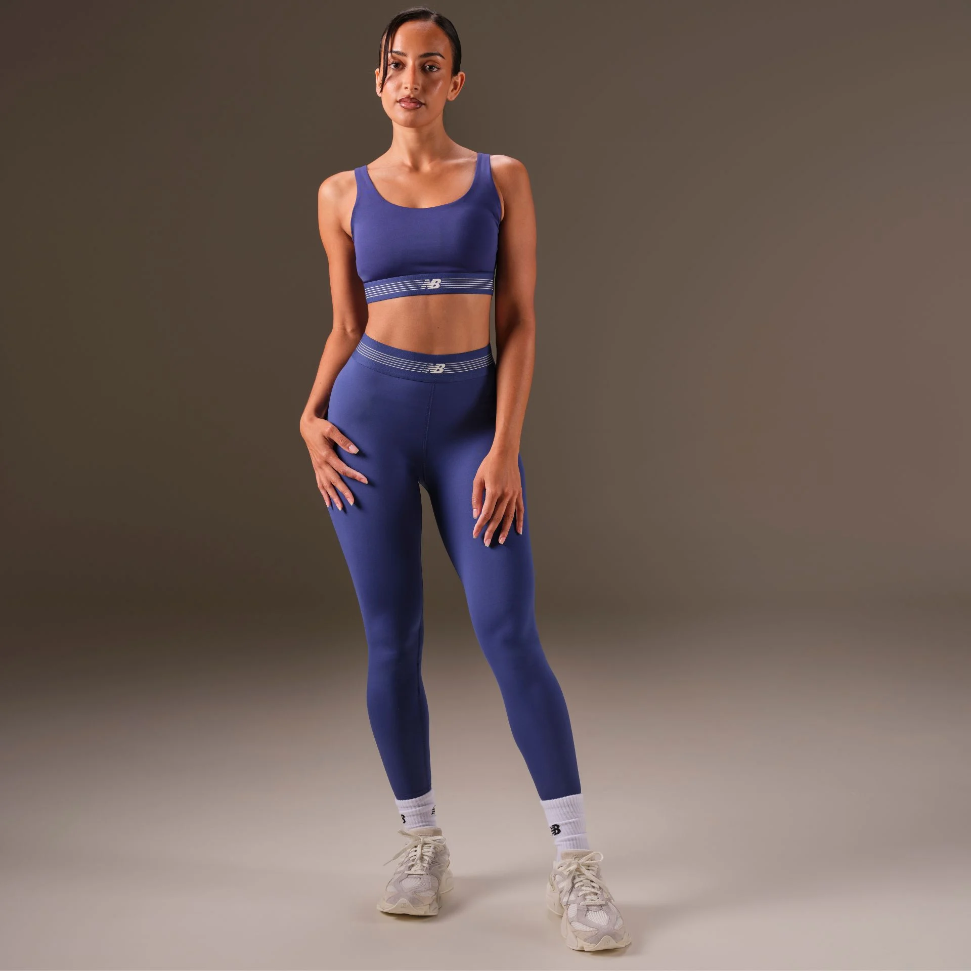 woman in studio background wearing 9060 sneakers