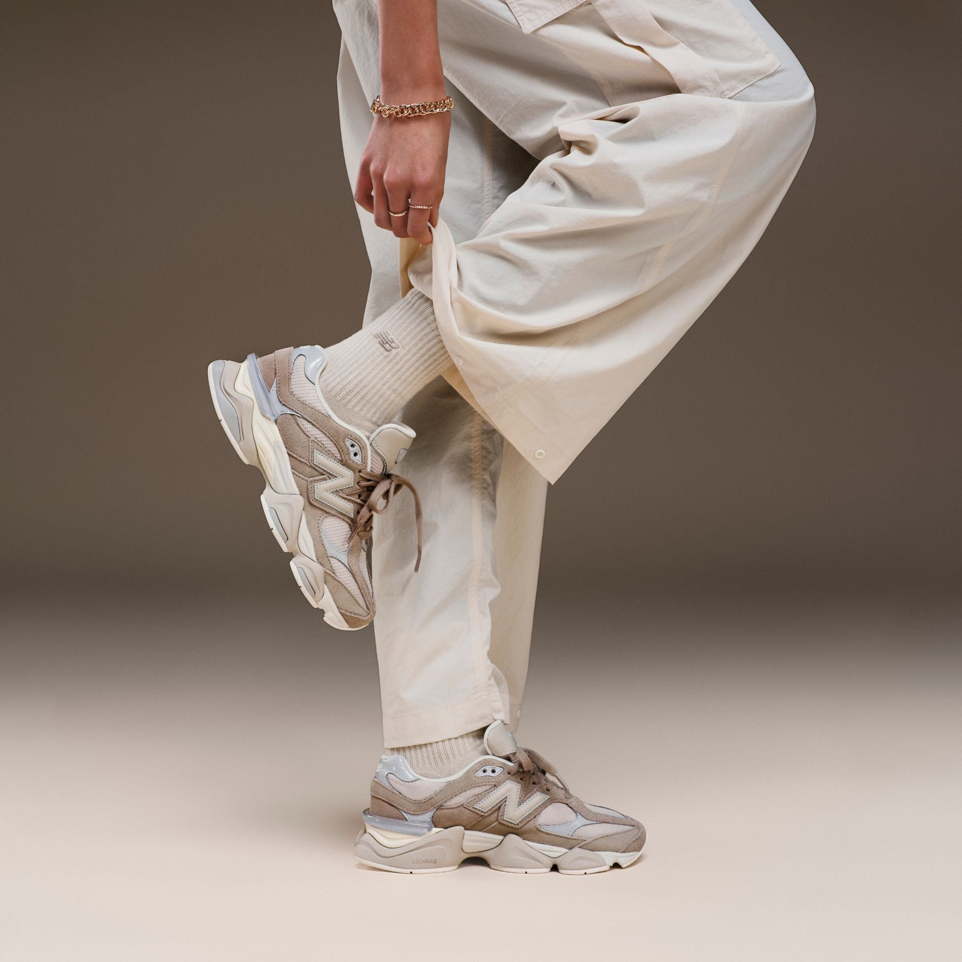 Woman in a studio background wearing 9060 sneakers
