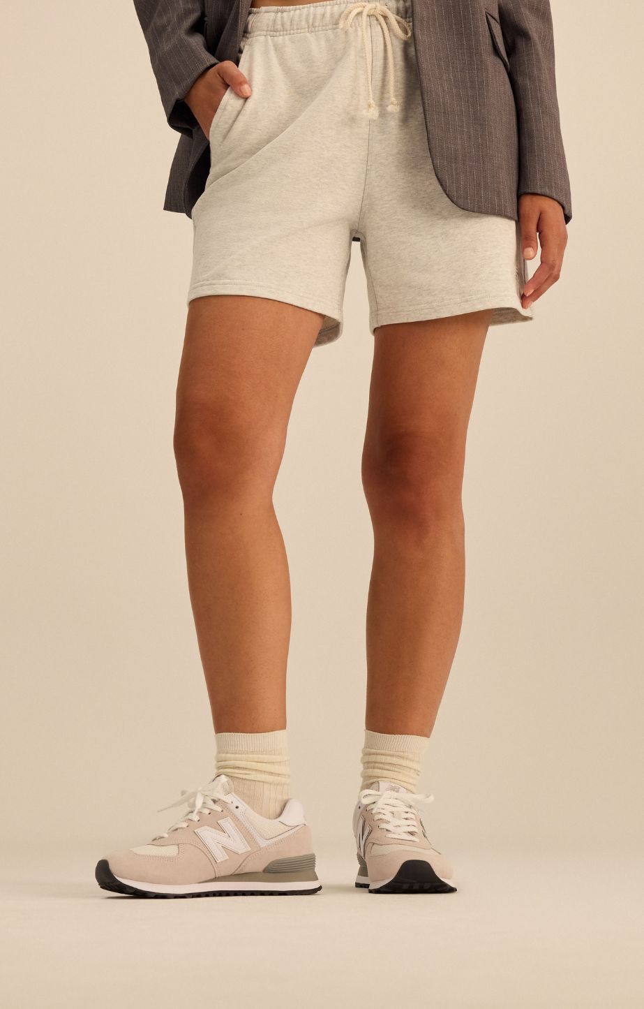 Woman standing wearing new balance 574 sneakers